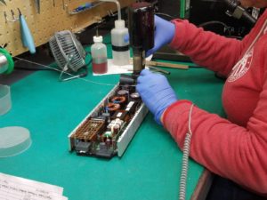 employee working on repairing telecom equipment